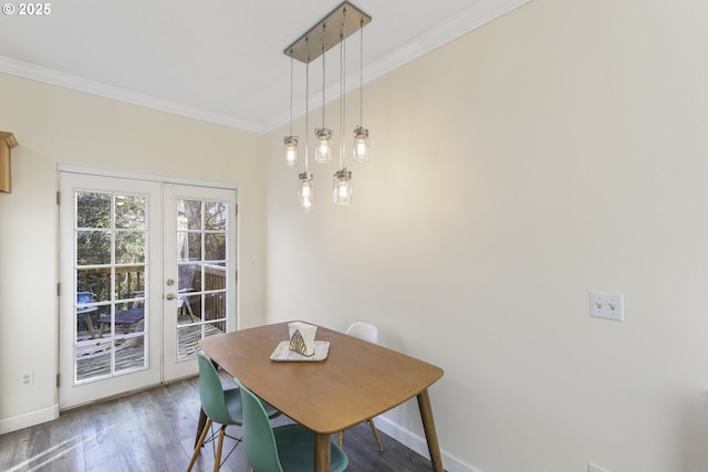 dining area featuring french doors, crown molding, and dark wood-type flooring