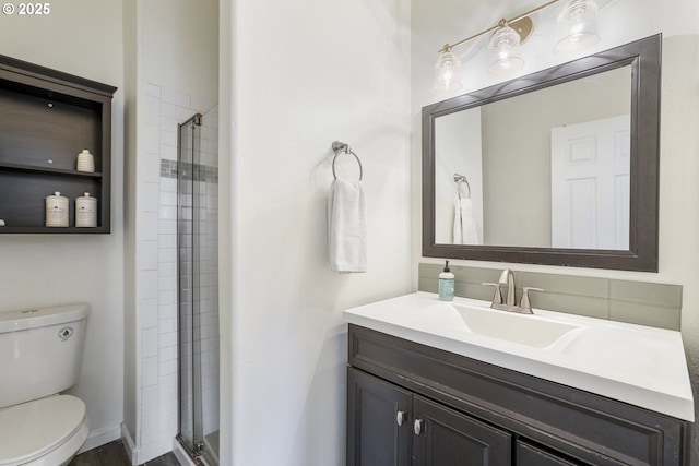 bathroom with vanity, toilet, and walk in shower