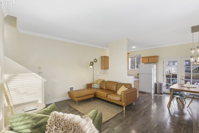 living room with french doors, dark wood-type flooring, and ornamental molding