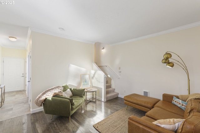 living room with hardwood / wood-style flooring and crown molding