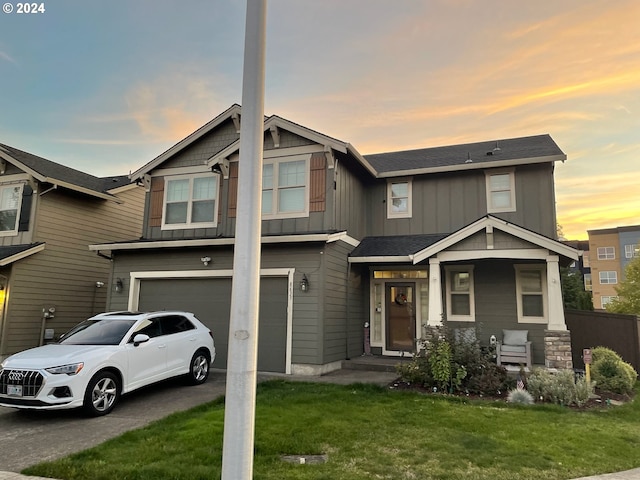 view of front of home featuring a lawn and a garage