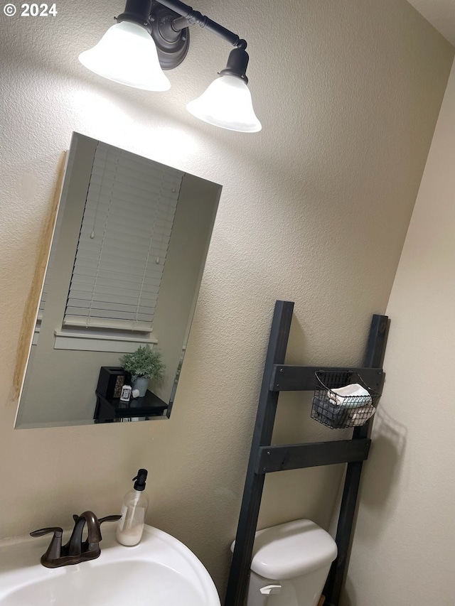 bathroom featuring toilet and sink