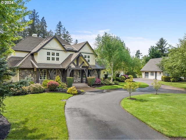 view of front of home featuring a front yard and a garage