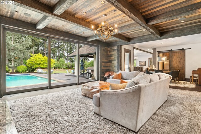 living room featuring a barn door, a wealth of natural light, and wood ceiling