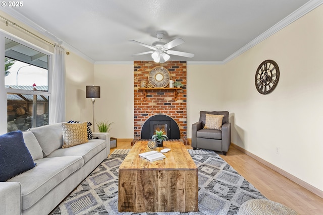 18685 SW Hennig Ct, Beaverton, OR 97003 - living room with ornamental molding, a brick fireplace, wood finished floors, ceiling fan, and baseboards