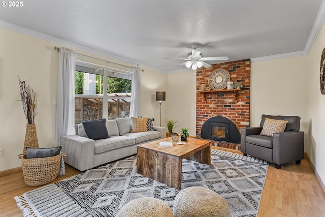 18685 SW Hennig Ct, Beaverton, OR 97003 - living area with wood finished floors, a ceiling fan, ornamental molding, baseboards, and a fireplace