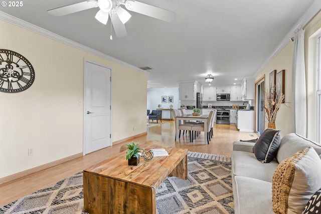 18685 SW Hennig Ct, Beaverton, OR 97003 - living room featuring ornamental molding, light wood-style flooring, ceiling fan, and baseboards