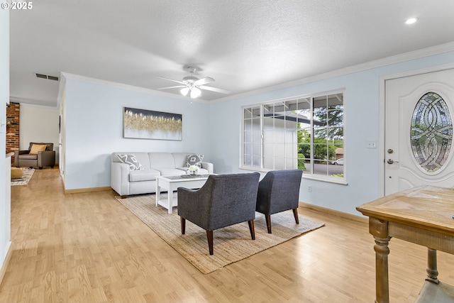 18685 SW Hennig Ct, Beaverton, OR 97003 - living room with crown molding, baseboards, light wood-style flooring, and a ceiling fan