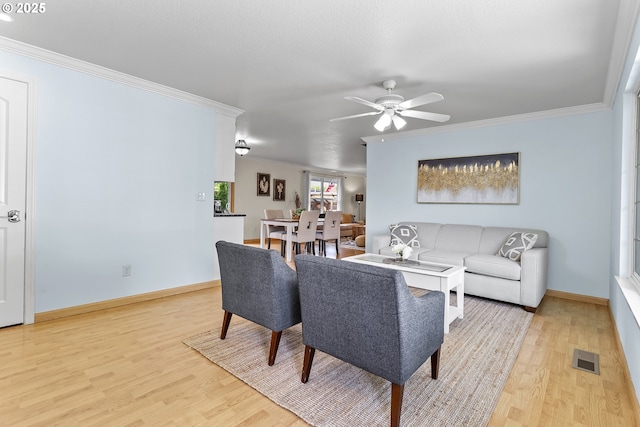 18685 SW Hennig Ct, Beaverton, OR 97003 - living room featuring light wood finished floors, ornamental molding, a ceiling fan, and baseboards