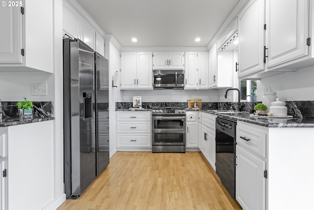 18685 SW Hennig Ct, Beaverton, OR 97003 - kitchen featuring stainless steel appliances, light wood-type flooring, white cabinets, recessed lighting, and a sink