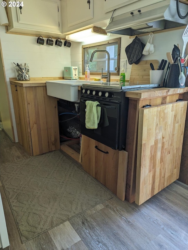 kitchen with light wood-type flooring and black electric range oven