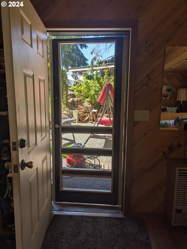 doorway featuring wood walls