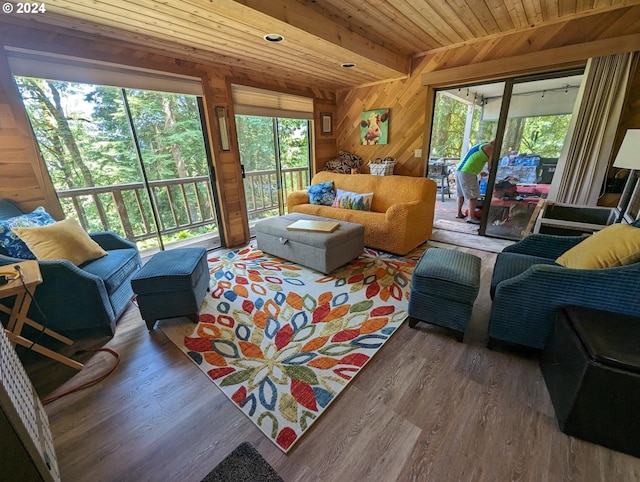 living room with hardwood / wood-style floors, wooden walls, and wooden ceiling