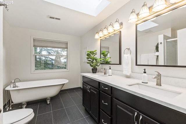 full bath with a skylight, a sink, visible vents, and tile patterned floors