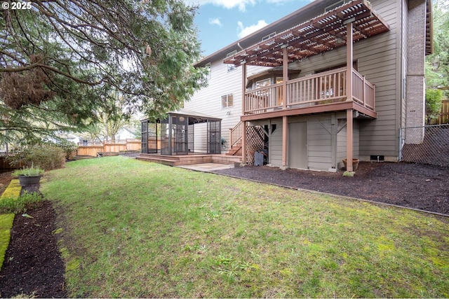 view of yard with a gazebo, a fenced backyard, a wooden deck, and a pergola