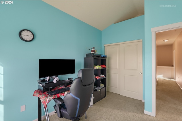 carpeted office space featuring vaulted ceiling