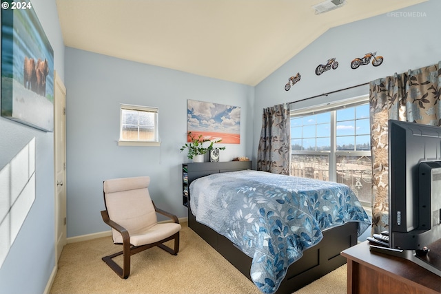 bedroom with lofted ceiling and light carpet