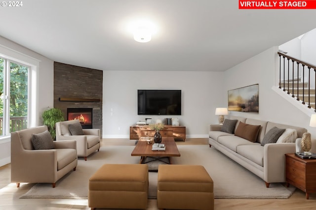 living room with a fireplace and light hardwood / wood-style floors