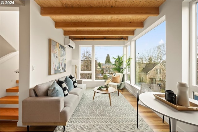 sunroom / solarium featuring beamed ceiling, wooden ceiling, and a wall unit AC