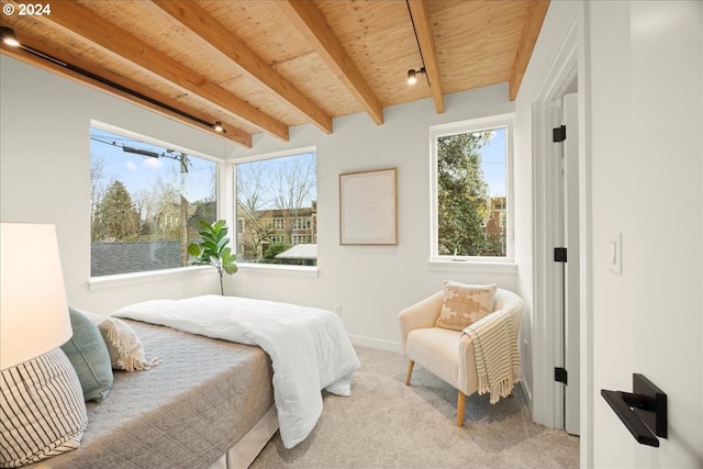 carpeted bedroom with beam ceiling and wood ceiling