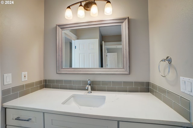 bathroom with tasteful backsplash and vanity