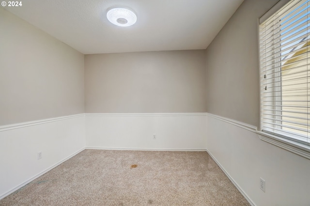 unfurnished room featuring light colored carpet