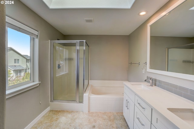 bathroom featuring tile patterned floors, vanity, a healthy amount of sunlight, and independent shower and bath