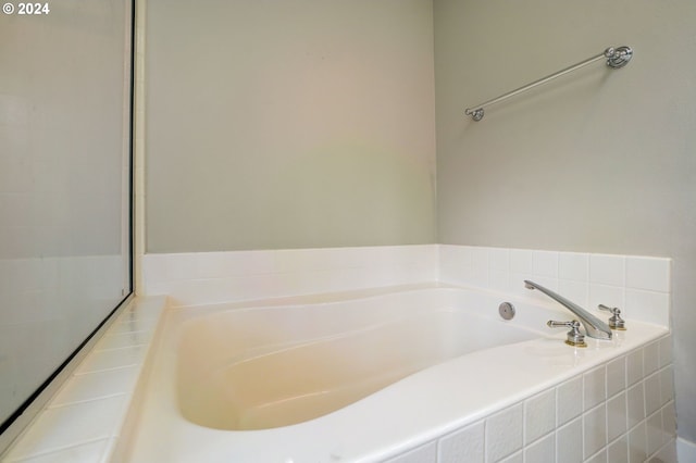 bathroom featuring tiled bath