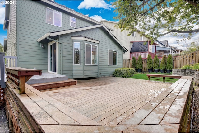 rear view of house featuring a wooden deck