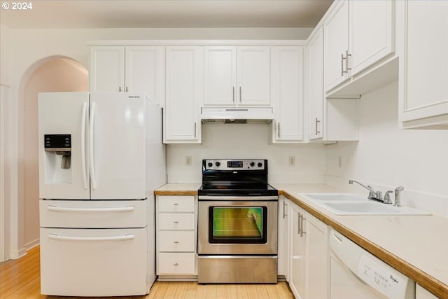 kitchen featuring dishwasher, hanging light fixtures, sink, white cabinetry, and light hardwood / wood-style floors