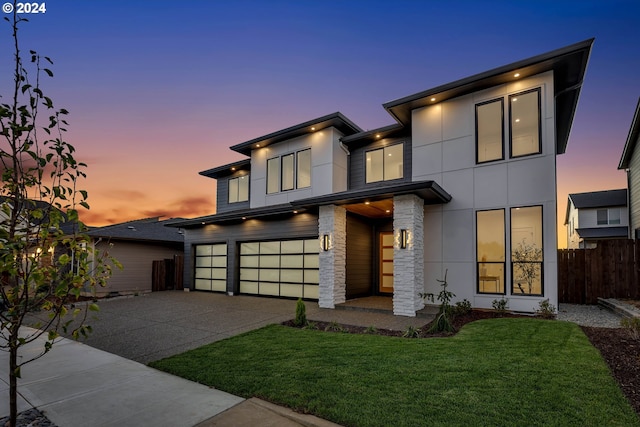 contemporary house with a garage and a lawn