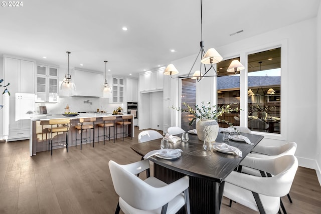 dining space featuring an inviting chandelier and dark hardwood / wood-style flooring