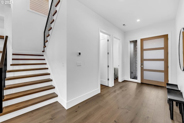 foyer entrance with dark hardwood / wood-style flooring