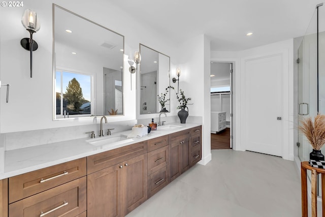 bathroom with vanity and a shower with shower door