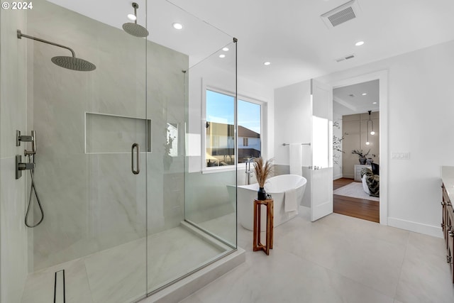 bathroom with vanity and independent shower and bath