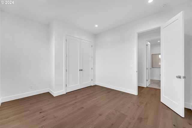 unfurnished bedroom with hardwood / wood-style flooring