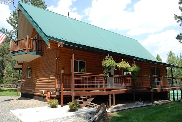 rear view of property featuring a balcony