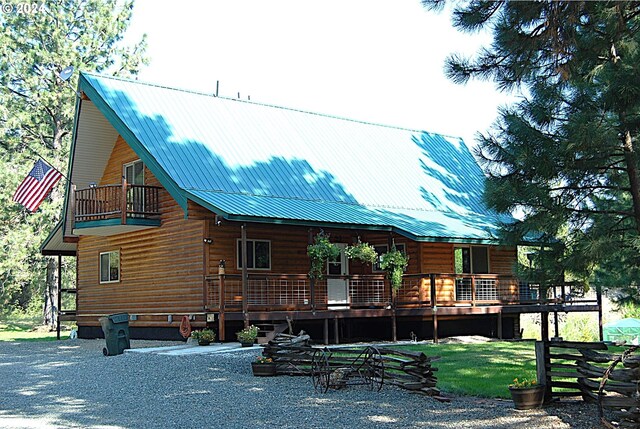 back of house featuring a balcony