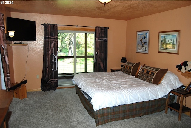 bedroom featuring carpet floors, access to outside, and a textured ceiling