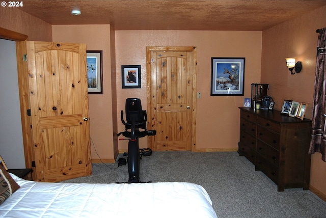 bedroom with carpet floors and a textured ceiling