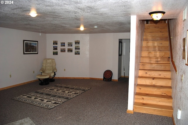 unfurnished room with a textured ceiling and carpet