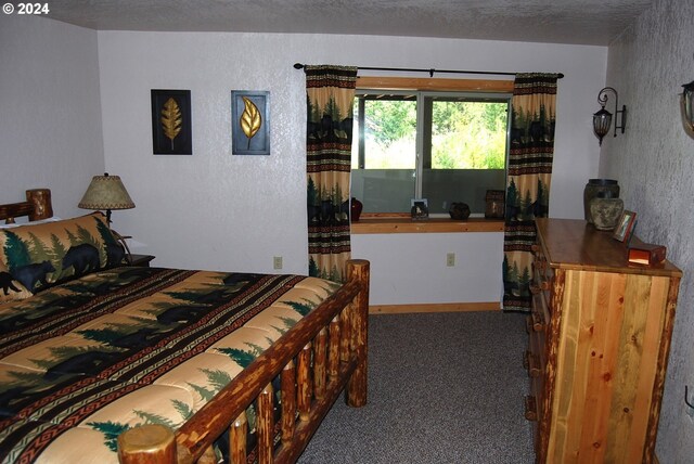 bedroom with carpet and a textured ceiling