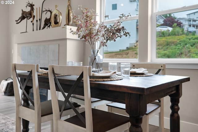 dining space with wood-type flooring