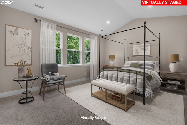 carpeted bedroom with lofted ceiling