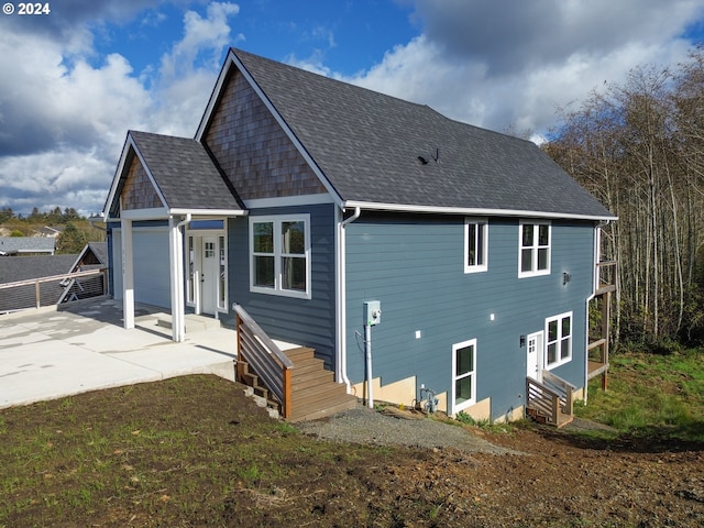 back of house with a garage