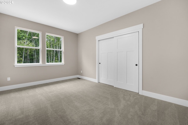 unfurnished bedroom with a closet and carpet floors