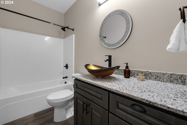 full bathroom with toilet, hardwood / wood-style floors, vanity, and bathing tub / shower combination