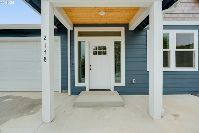 doorway to property with a garage