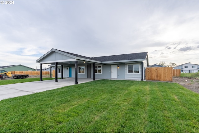 ranch-style house with a front lawn and a carport