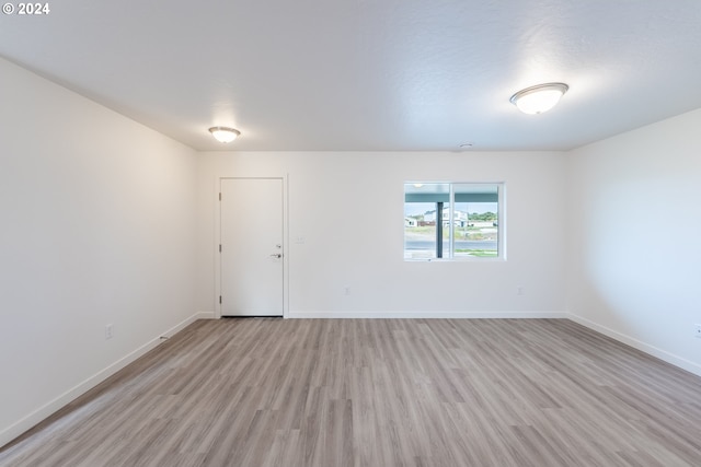 unfurnished room with light hardwood / wood-style floors